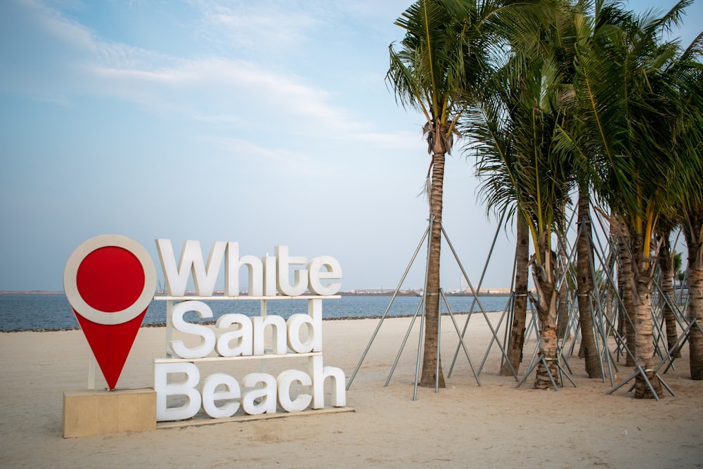 a sign on the beach that says white sand beach