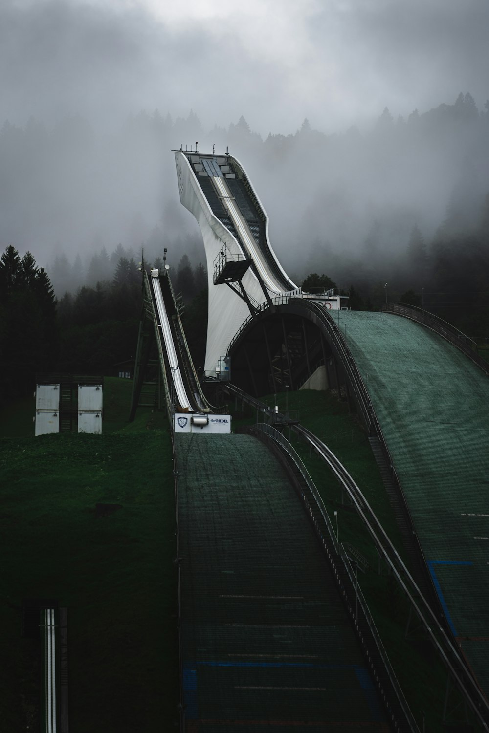 a train traveling over a bridge on a foggy day