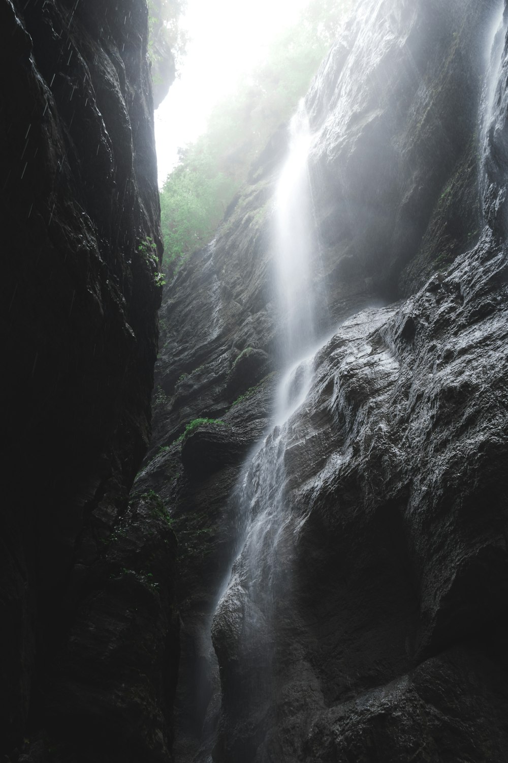 a large waterfall is coming out of a cave