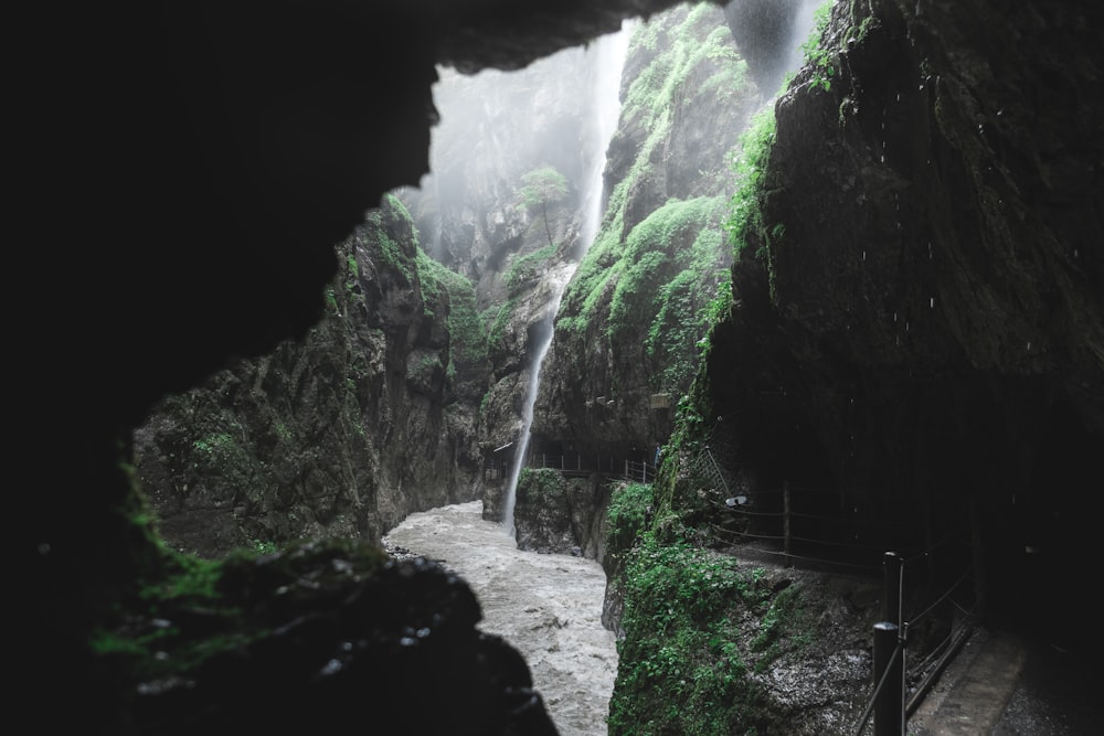 a small waterfall in the middle of a mountain