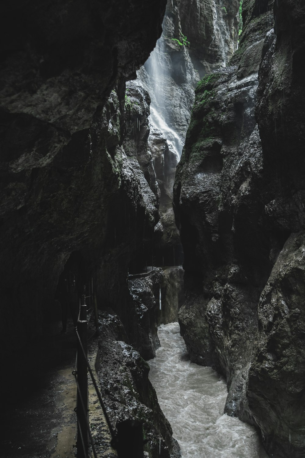 a small waterfall in the middle of a canyon