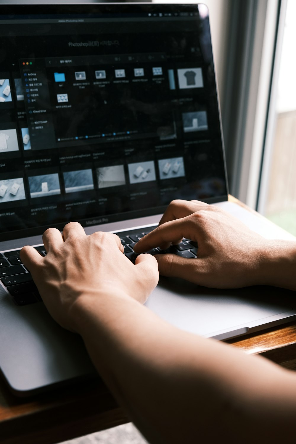 a person typing on a laptop on a desk