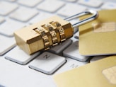 a golden padlock sitting on top of a keyboard