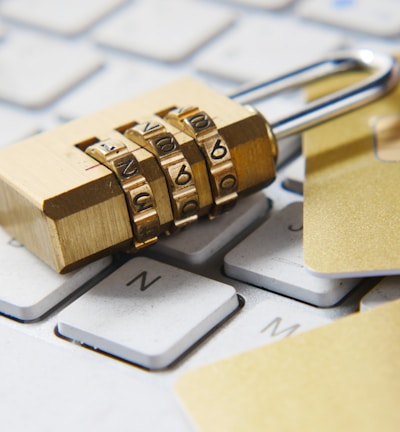 a golden padlock sitting on top of a keyboard