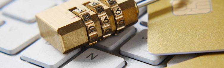 a golden padlock sitting on top of a keyboard