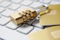 a golden padlock sitting on top of a keyboard