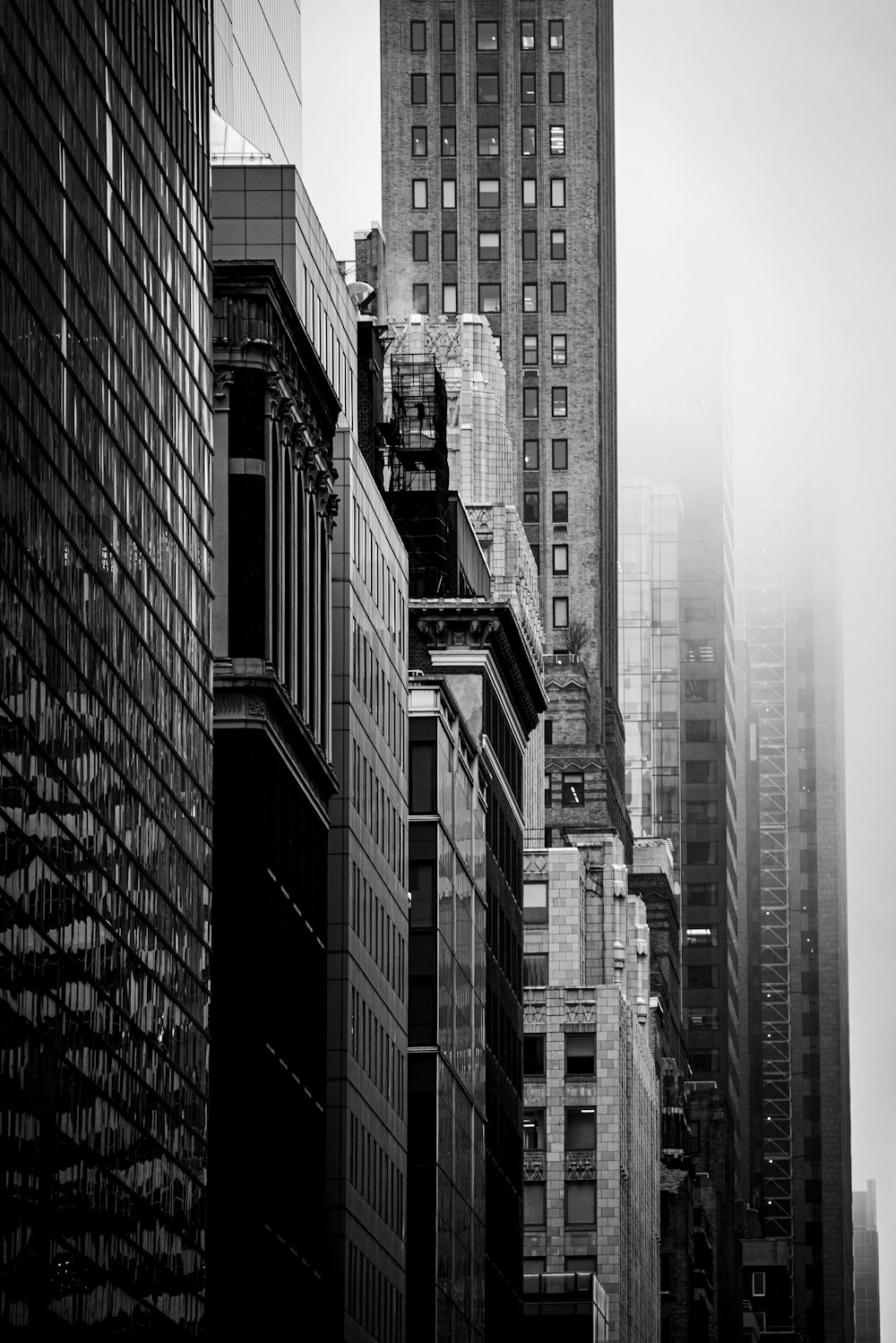 a black and white photo of a city with tall buildings