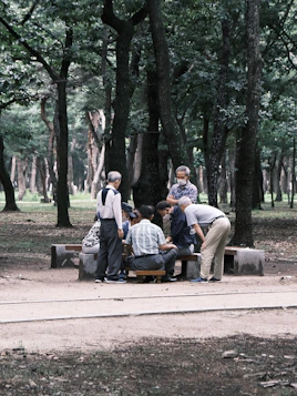A group of retirees laughing together during a community gardening event.