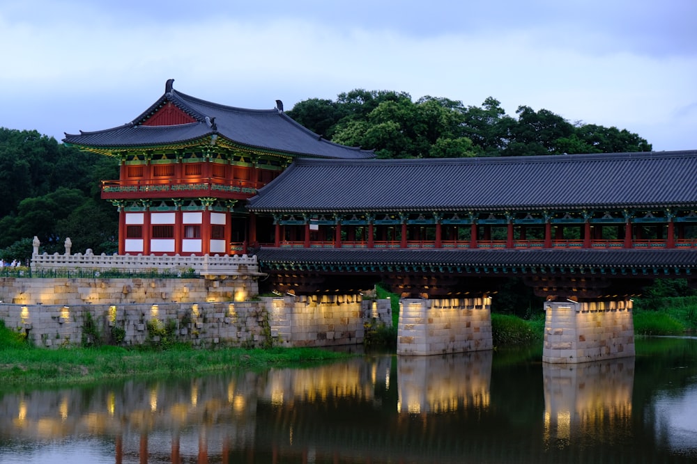 a bridge over a body of water with a building in the background