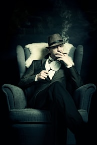 Detective sitting in a chair smoking a cigarette