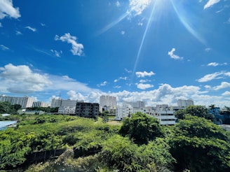 A vibrant cityscape with modern apartments and a clear blue sky.