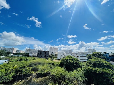 A vibrant cityscape with modern apartments and a clear blue sky.
