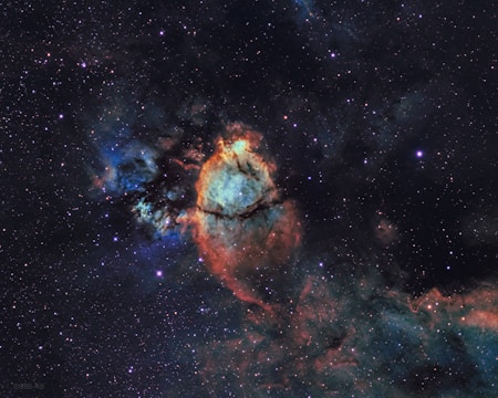 An artistic representation of a nebula in dark colors.