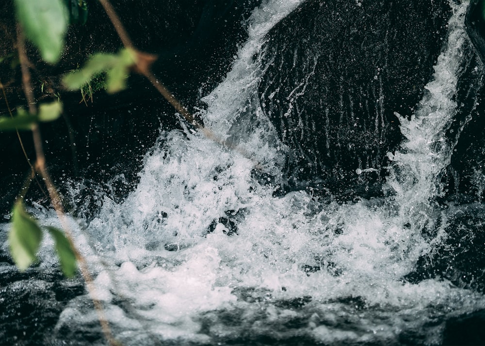 a close up of a waterfall with water coming out of it