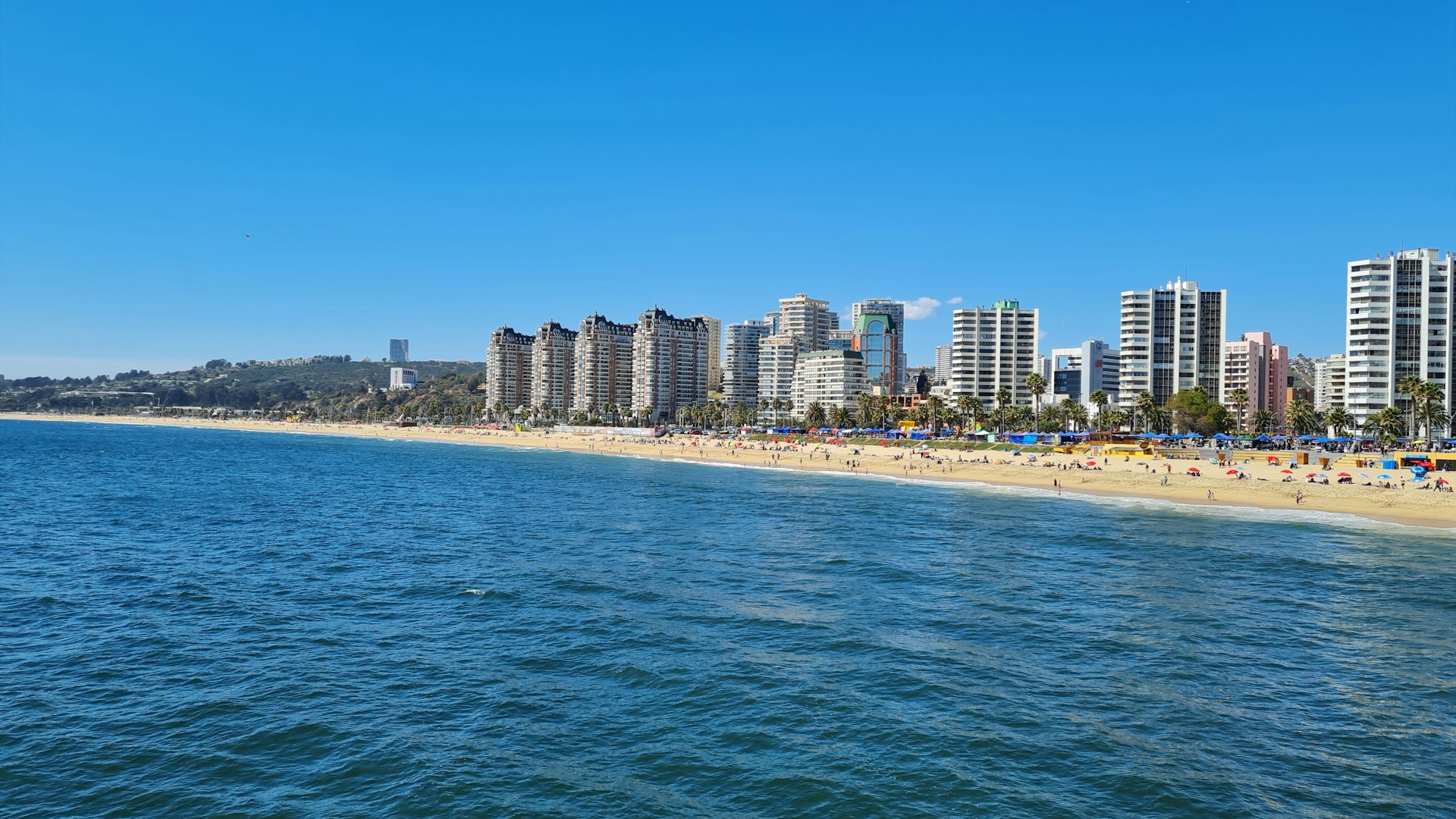 a beach with a bunch of tall buildings in the background
