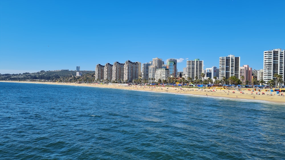 a beach with a bunch of tall buildings in the background