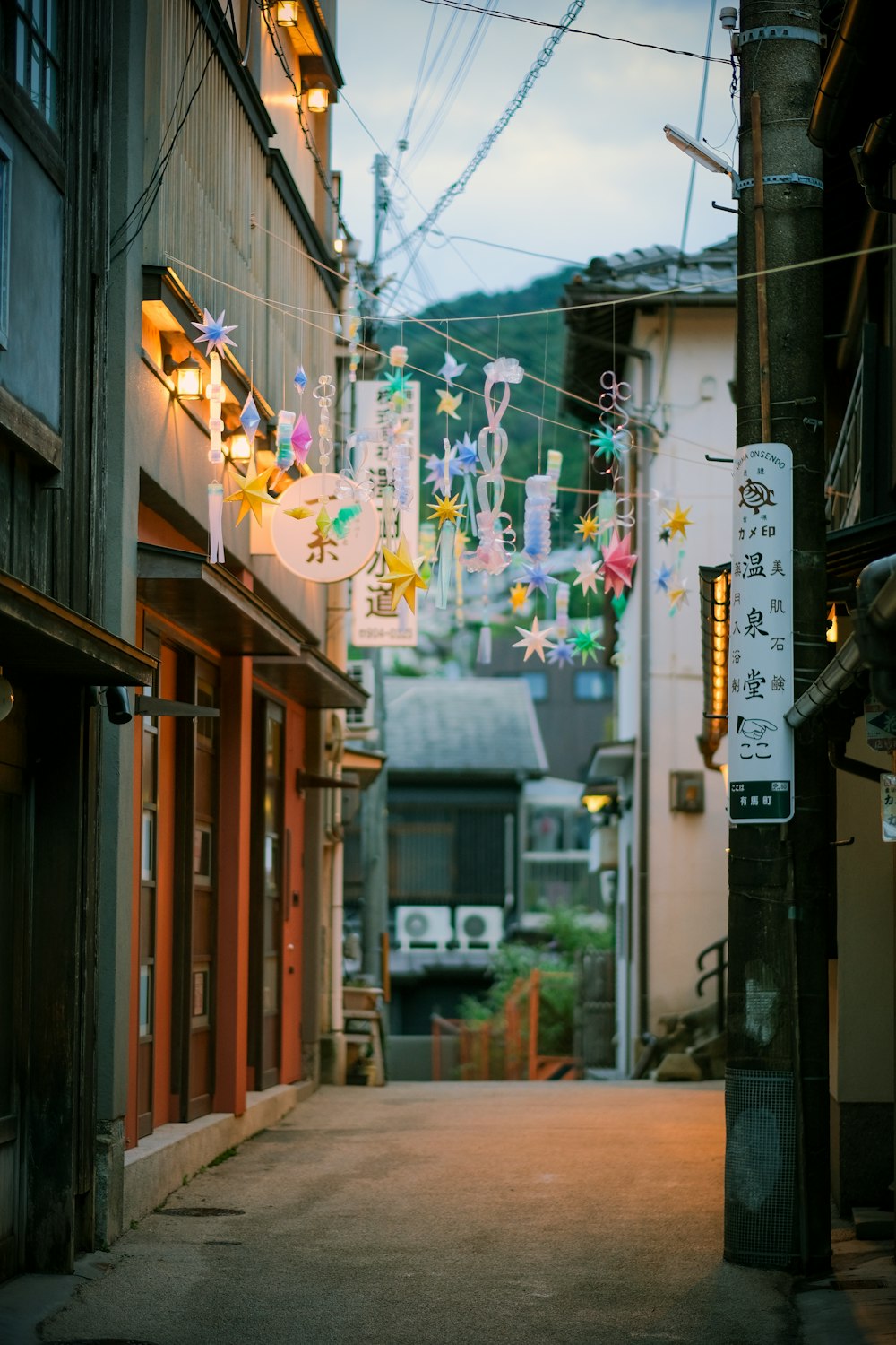 a narrow alley way with a sign hanging from the side of it