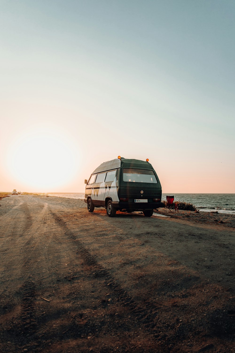 a van parked on the side of a road near the ocean