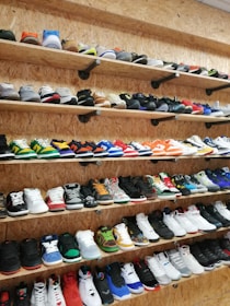 Colorful sneakers arranged on a wooden floor.