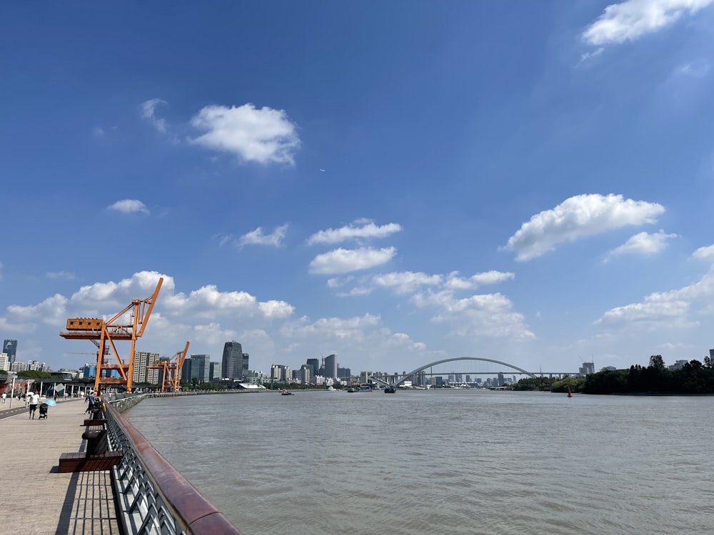 a view of a river with a bridge in the background