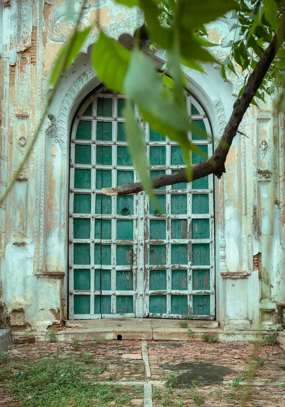 an old building with a green door and window