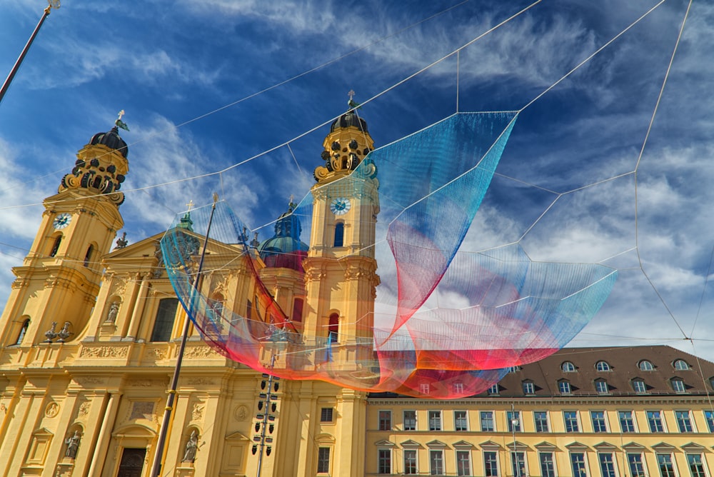 a large building with a very colorful kite in front of it