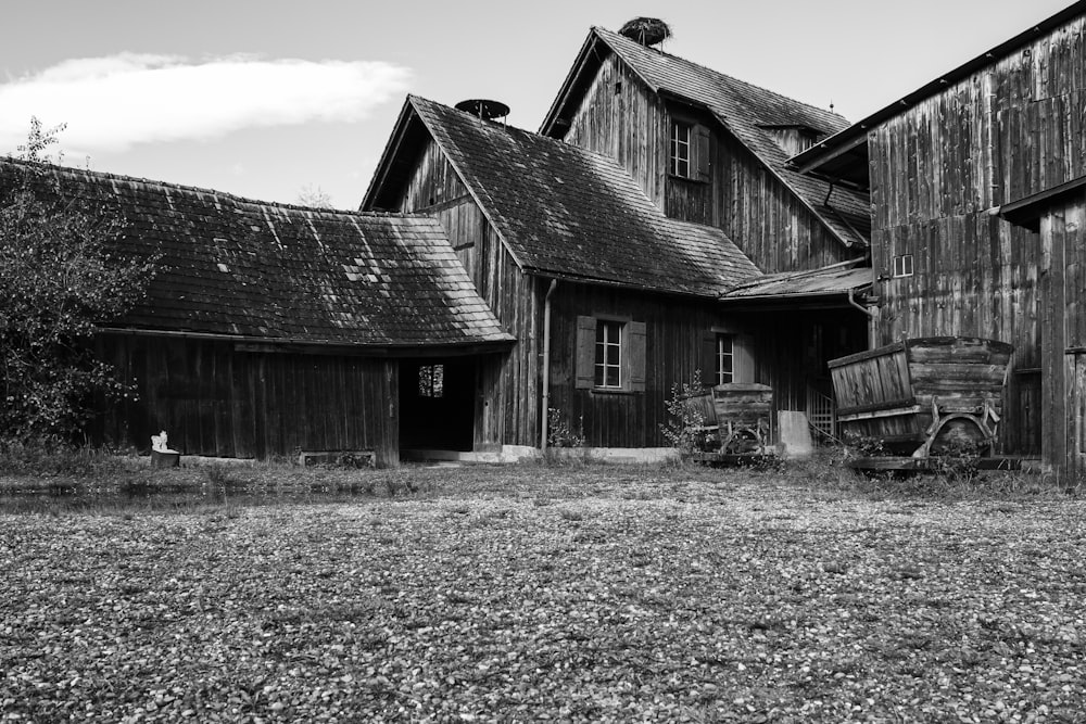 a black and white photo of an old barn