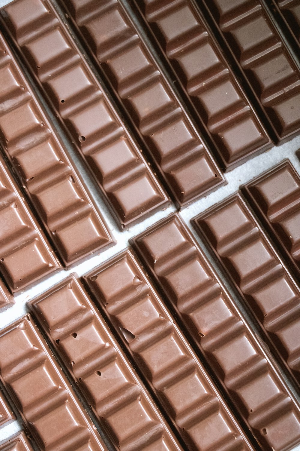 several rows of chocolate bars lined up on a table