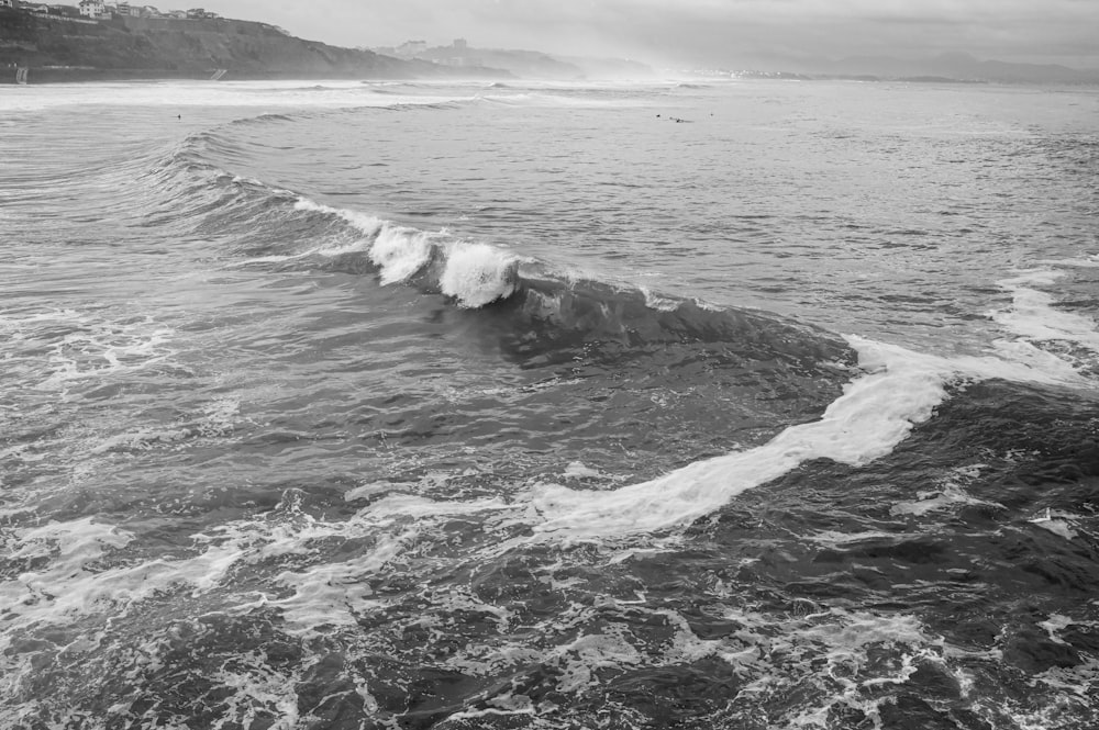 a black and white photo of the ocean waves