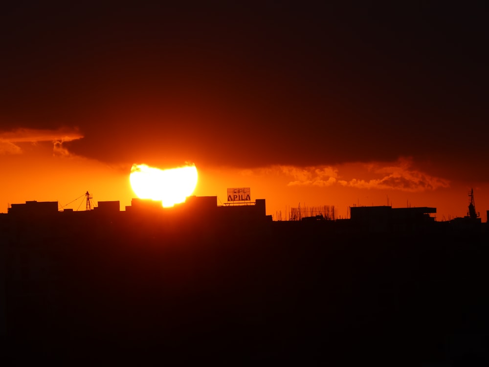 the sun is setting over a city skyline