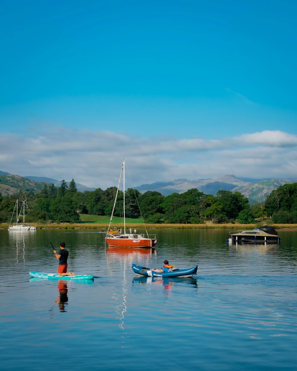 two people in kayaks paddling on a lake