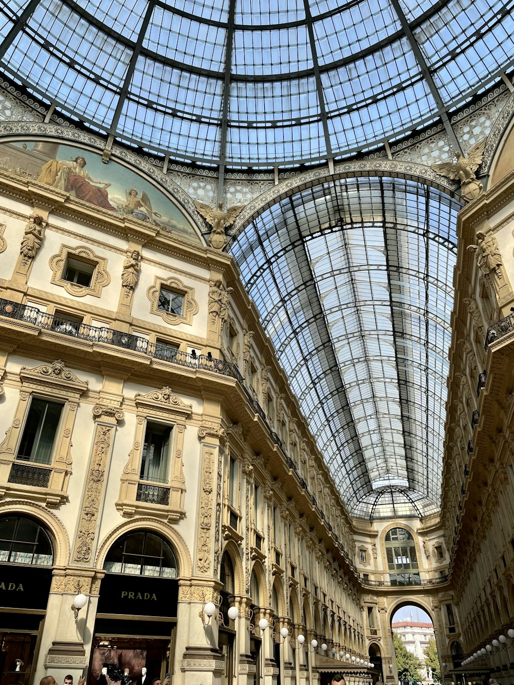 a large building with a glass ceiling and people walking around