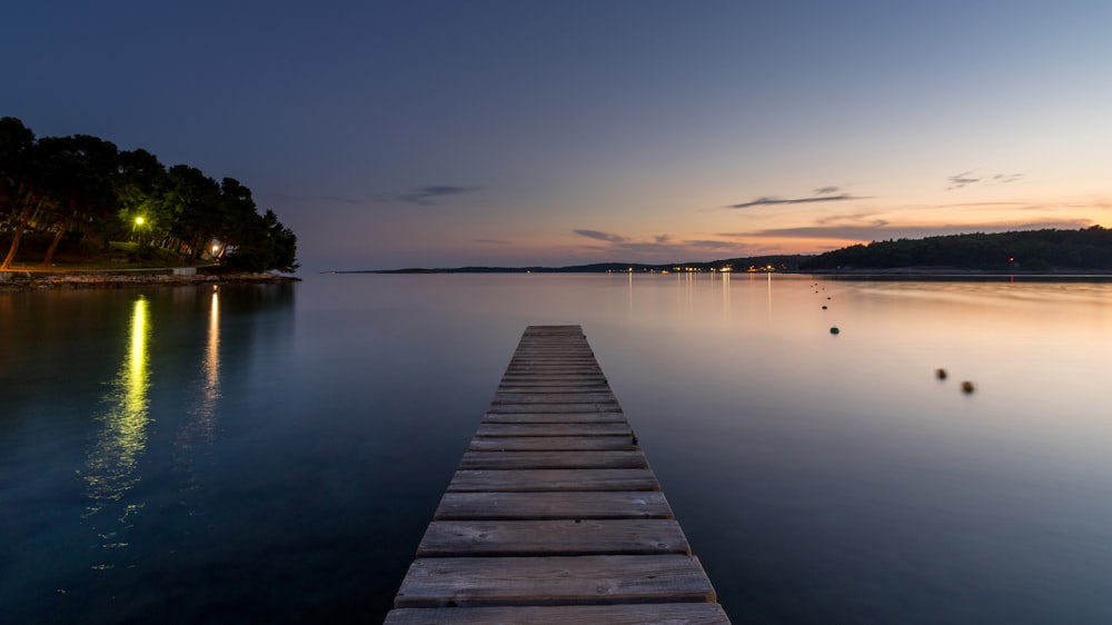 a long wooden dock in the middle of a body of water