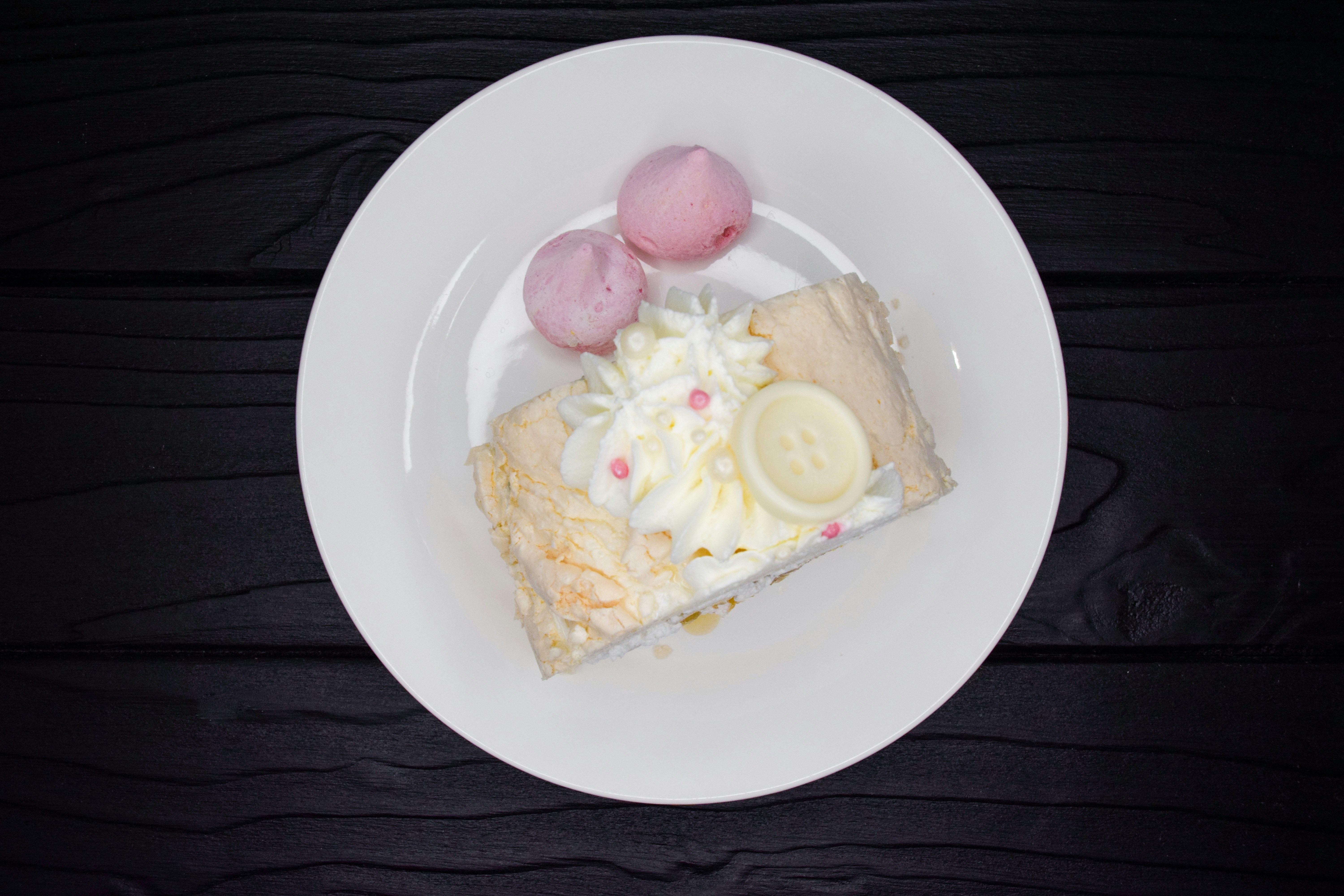 a white plate topped with a slice of cake
