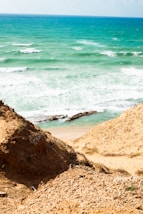 a person standing on a beach next to the ocean