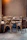 A cozy corner of the restaurant showing brick walls and comfortable seating with a couple chatting happily.