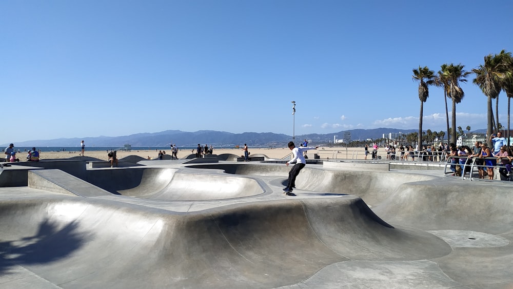 a man riding a skateboard up the side of a ramp