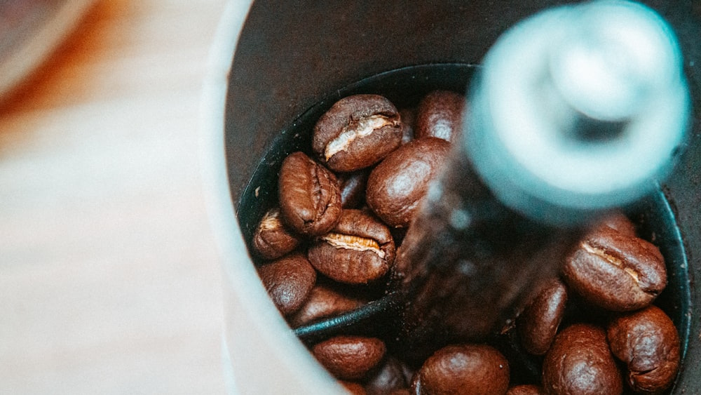 a coffee grinder filled with lots of coffee beans