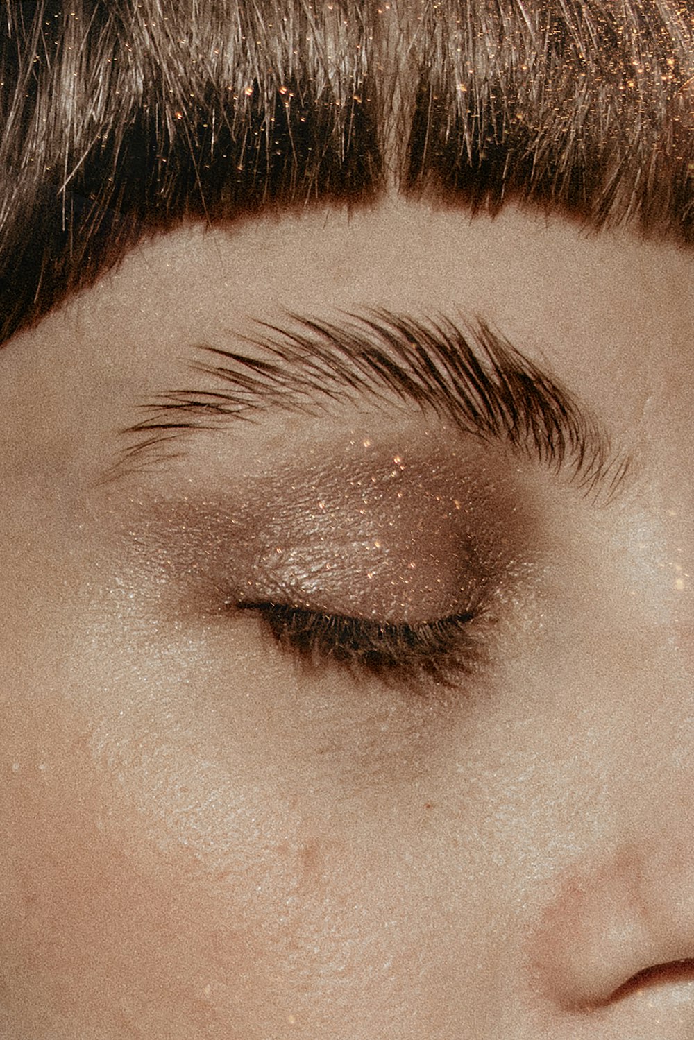 a close up of a woman's eye with glitter on it