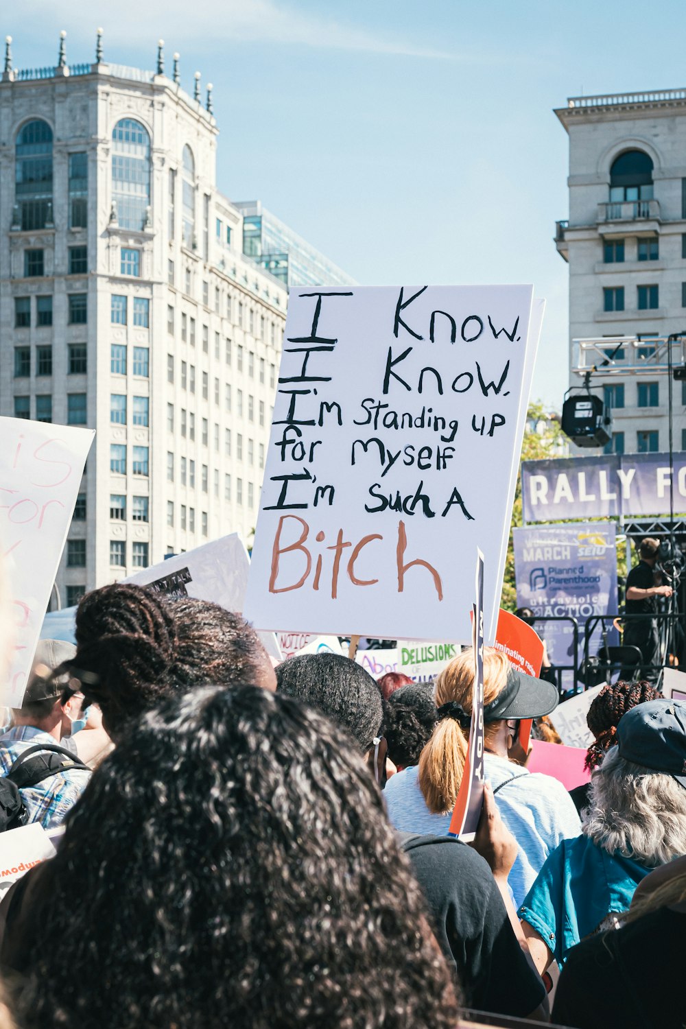 a group of people holding signs in the street