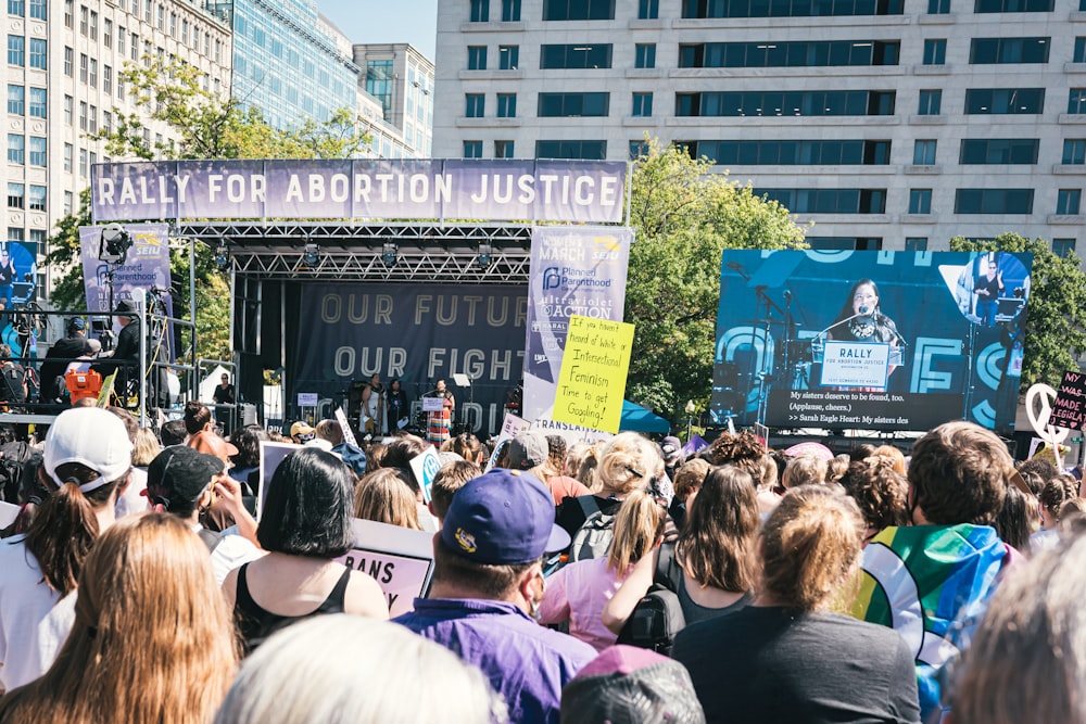 a large group of people standing in front of a stage