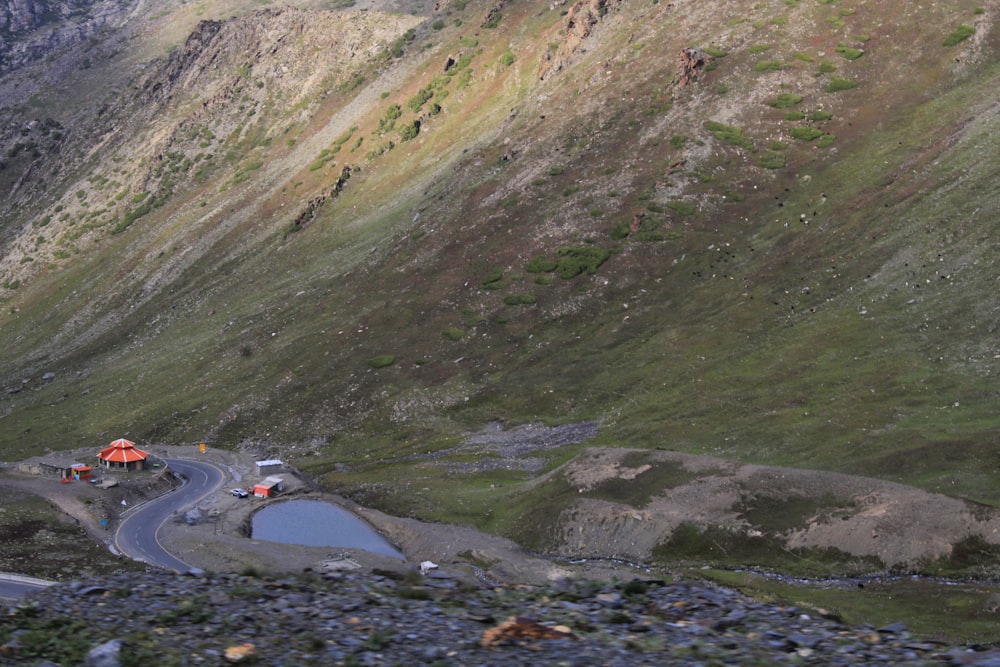 a winding road with a mountain in the background