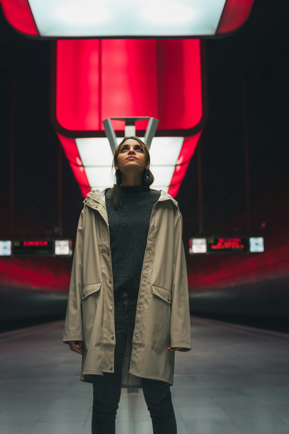 a woman standing in front of a red wall