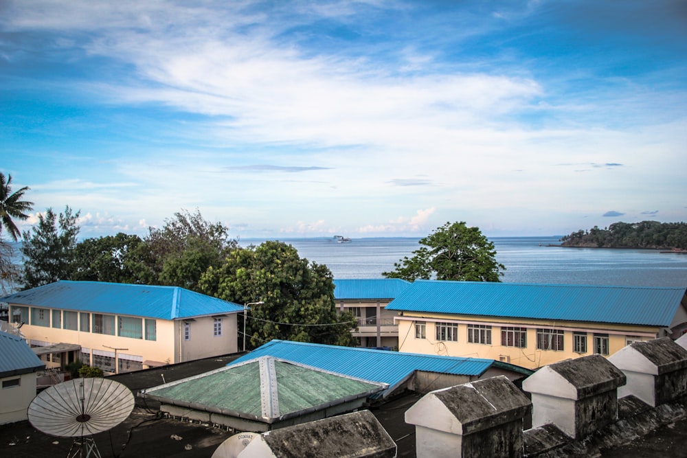 a group of buildings with a body of water in the background