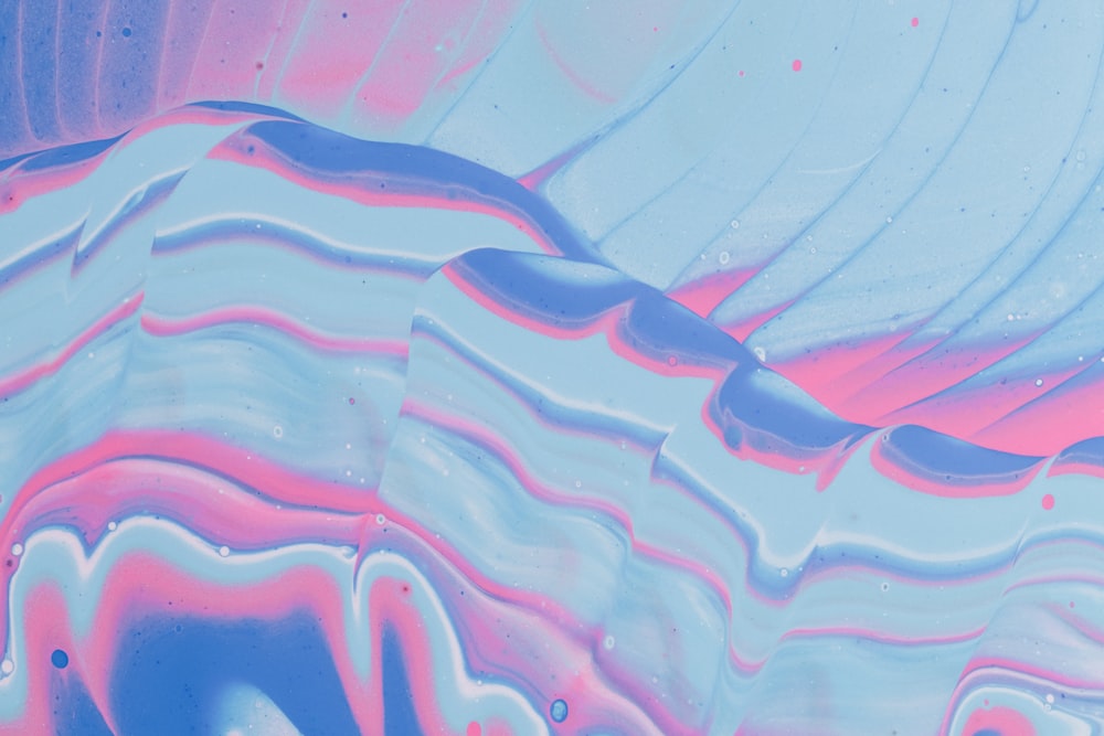 a close up of a blue and pink background