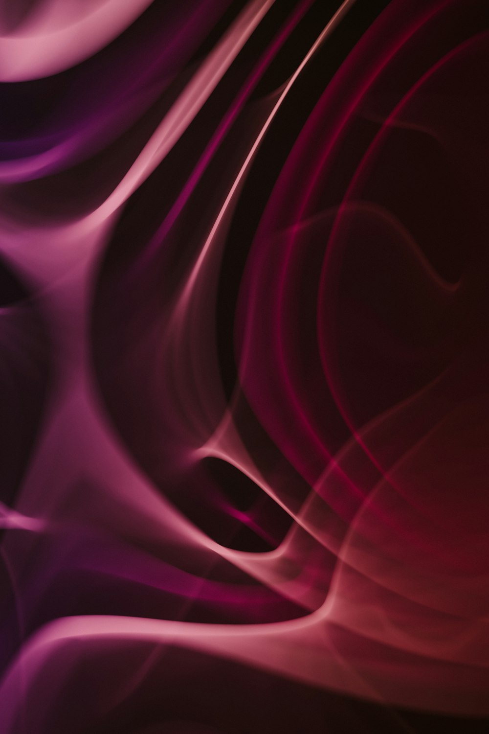 a red and purple abstract background with wavy lines