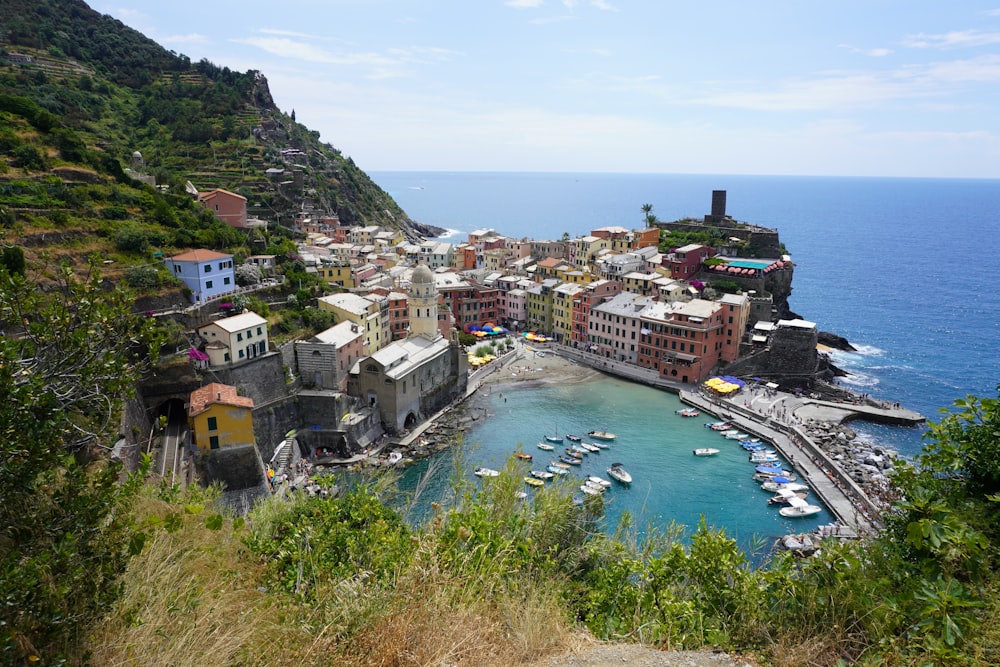 a small village on a cliff overlooking a body of water