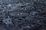 Close-up of industrial metal surfaces being cleaned with high-pressure water.