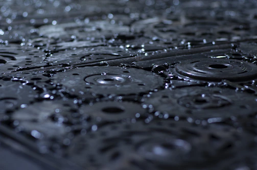 Close-up of industrial metal surfaces being cleaned with high-pressure water.
