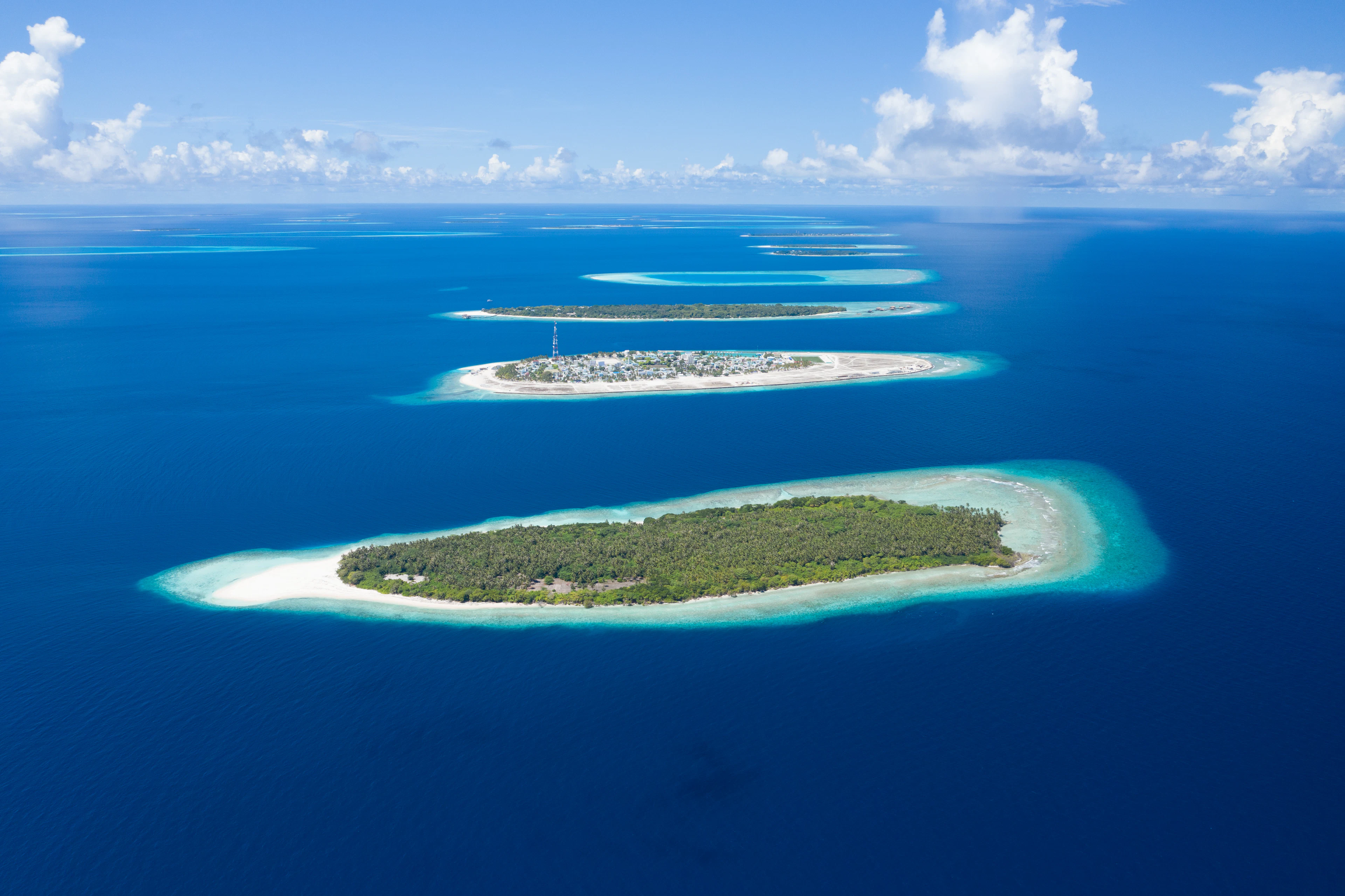 A line of islands with white sand and lagoons in Baa Atoll, Maldives